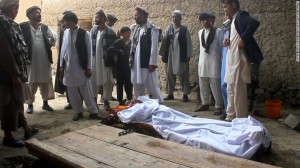 Afghan residents and relatives stands over the bodies of victims after a gunfight broke out at a wedding party at Deh Salah district of Baghlan Province killing 21 people. 