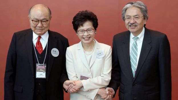 Candidates Woo Kwok-hing, Carrie Lam and John Tsang pose as they greet election committee members on Sunday 